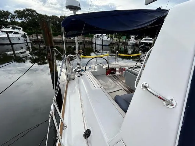  Yacht Photos Pics 2016 Beneteau Oceanis 45 sailboat docked at marina, featuring spacious deck and seating area.