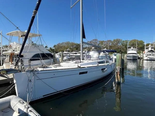  Yacht Photos Pics 2016 Beneteau Oceanis 45 sailboat docked at a marina under clear blue skies.