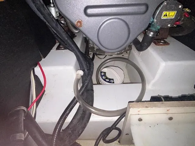  Yacht Photos Pics Engine compartment of a 2016 Beneteau Oceanis 45 sailboat, showing hoses and components.
