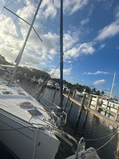  Yacht Photos Pics 2016 Beneteau Oceanis 45 sailboat docked at a marina under a blue sky.