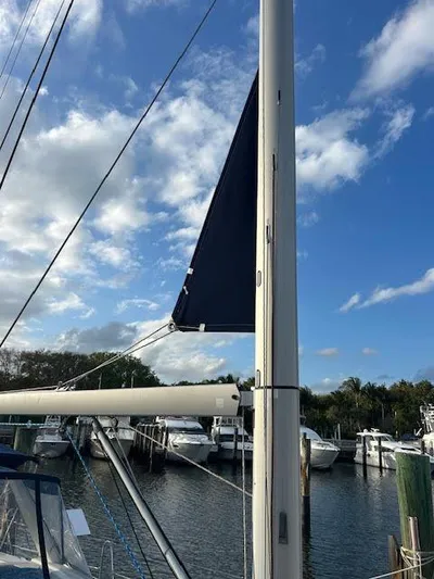  Yacht Photos Pics 2016 Beneteau Oceanis 45 sailboat mast against a blue sky at a marina.