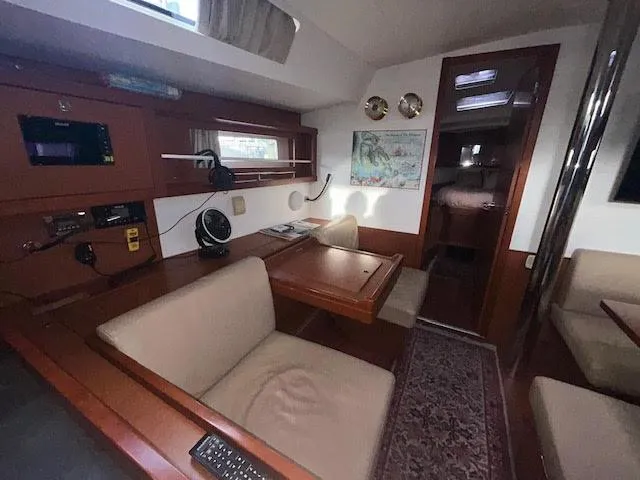  Yacht Photos Pics Interior of 2016 Beneteau Oceanis 45 yacht with cozy seating and wooden finishes.