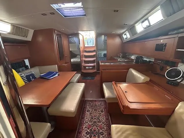  Yacht Photos Pics Interior of 2016 Beneteau Oceanis 45 yacht, featuring dining area and kitchen.