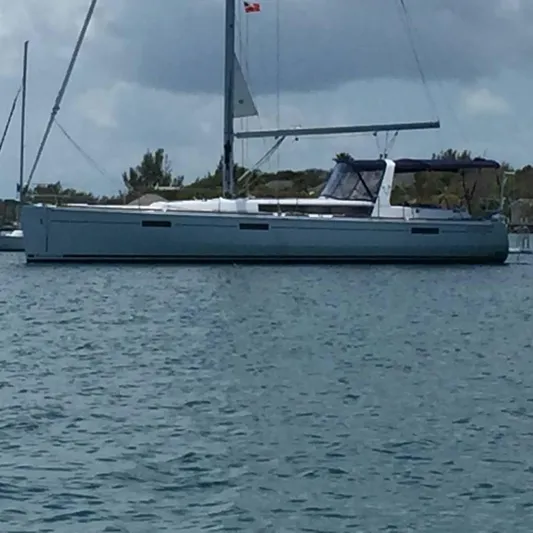  Yacht Photos Pics 2016 Beneteau Oceanis 45 sailboat anchored on calm water under cloudy sky.