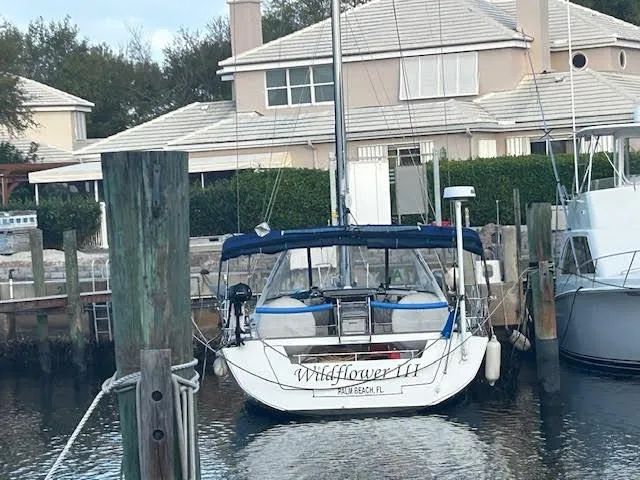  Yacht Photos Pics 2016 Beneteau Oceanis 45 sailboat docked at marina, residential background.