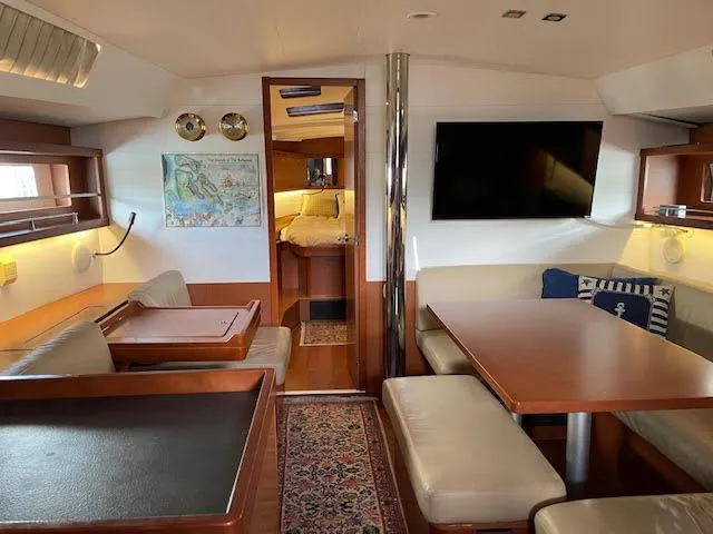  Yacht Photos Pics Interior of 2016 Beneteau Oceanis 45 yacht with modern seating and dining area.