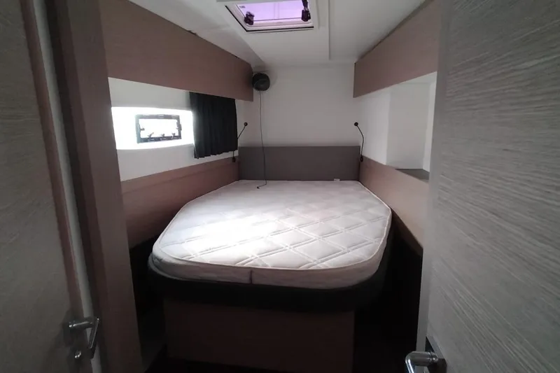  Yacht Photos Pics 2021 Fountaine Pajot Catamaran Astrea 42 cabin with bed and window view.