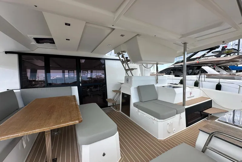  Yacht Photos Pics 2021 Fountaine Pajot Catamaran Astrea 42 interior with seating and dining area.