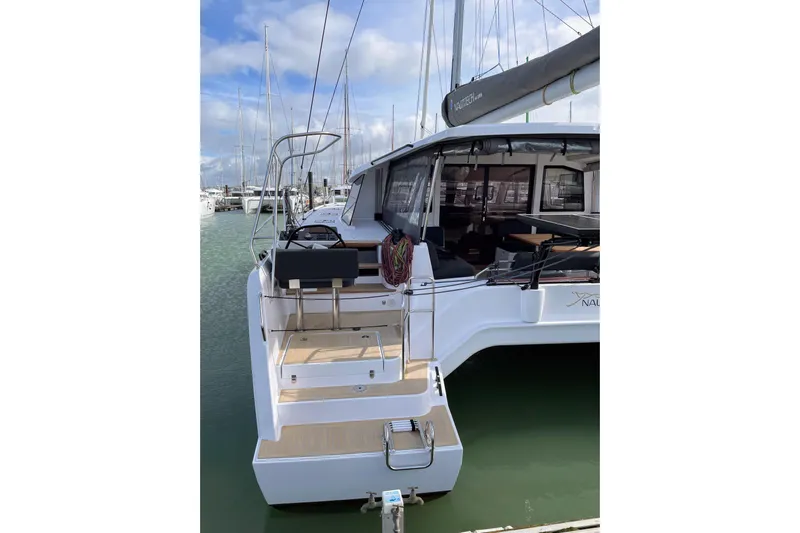  Yacht Photos Pics Nautitech 44 Open 2022 catamaran docked at marina, showcasing spacious deck and modern design.