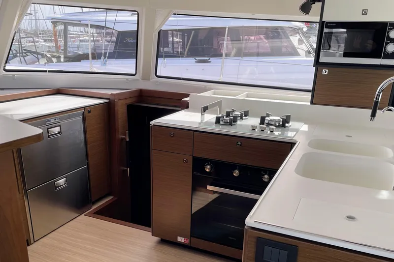  Yacht Photos Pics Modern kitchen interior of 2022 Nautitech 44 Open yacht with stove, sink, and appliances.