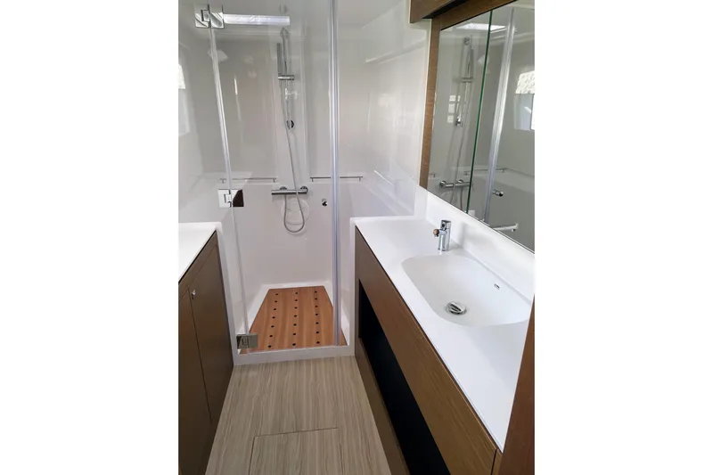  Yacht Photos Pics Modern bathroom interior on 2022 Nautitech 44 Open yacht, featuring sleek shower and sink.