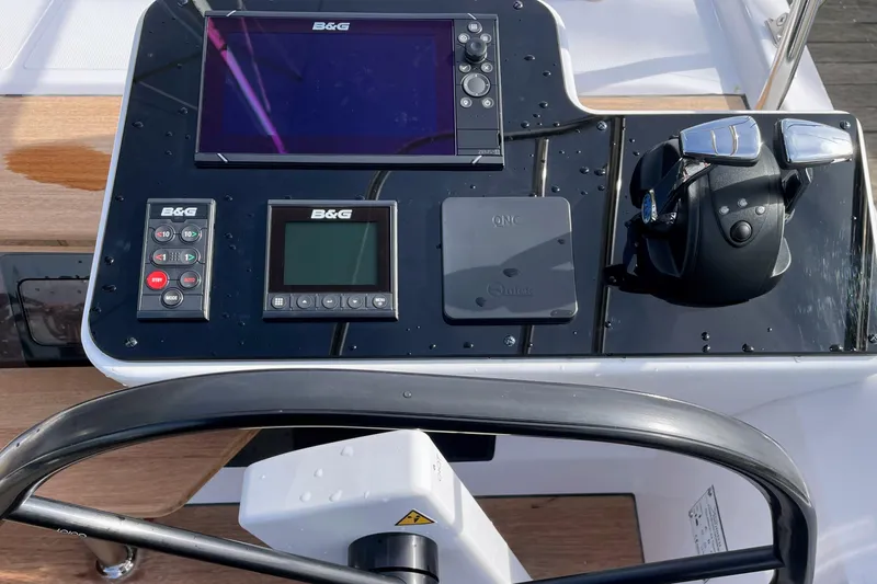  Yacht Photos Pics Control panel of 2022 Nautitech 44 Open catamaran with navigation equipment and steering wheel.
