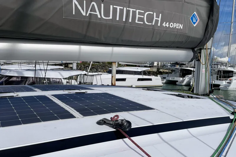  Yacht Photos Pics 2022 Nautitech 44 Open catamaran with solar panels, docked in a marina.
