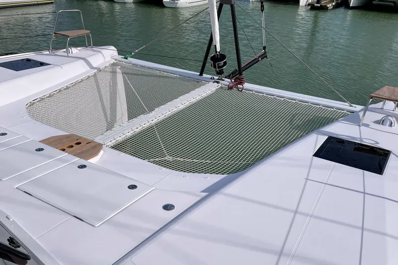  Yacht Photos Pics 2022 Nautitech 44 Open catamaran with netted deck, docked in marina.
