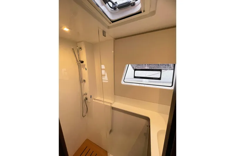  Yacht Photos Pics Modern shower area in 2022 Nautitech 44 Open yacht with window and sleek design.