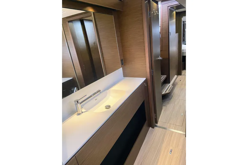  Yacht Photos Pics Luxurious bathroom interior of 2022 Nautitech 44 Open yacht, featuring modern sink and wood finishes.