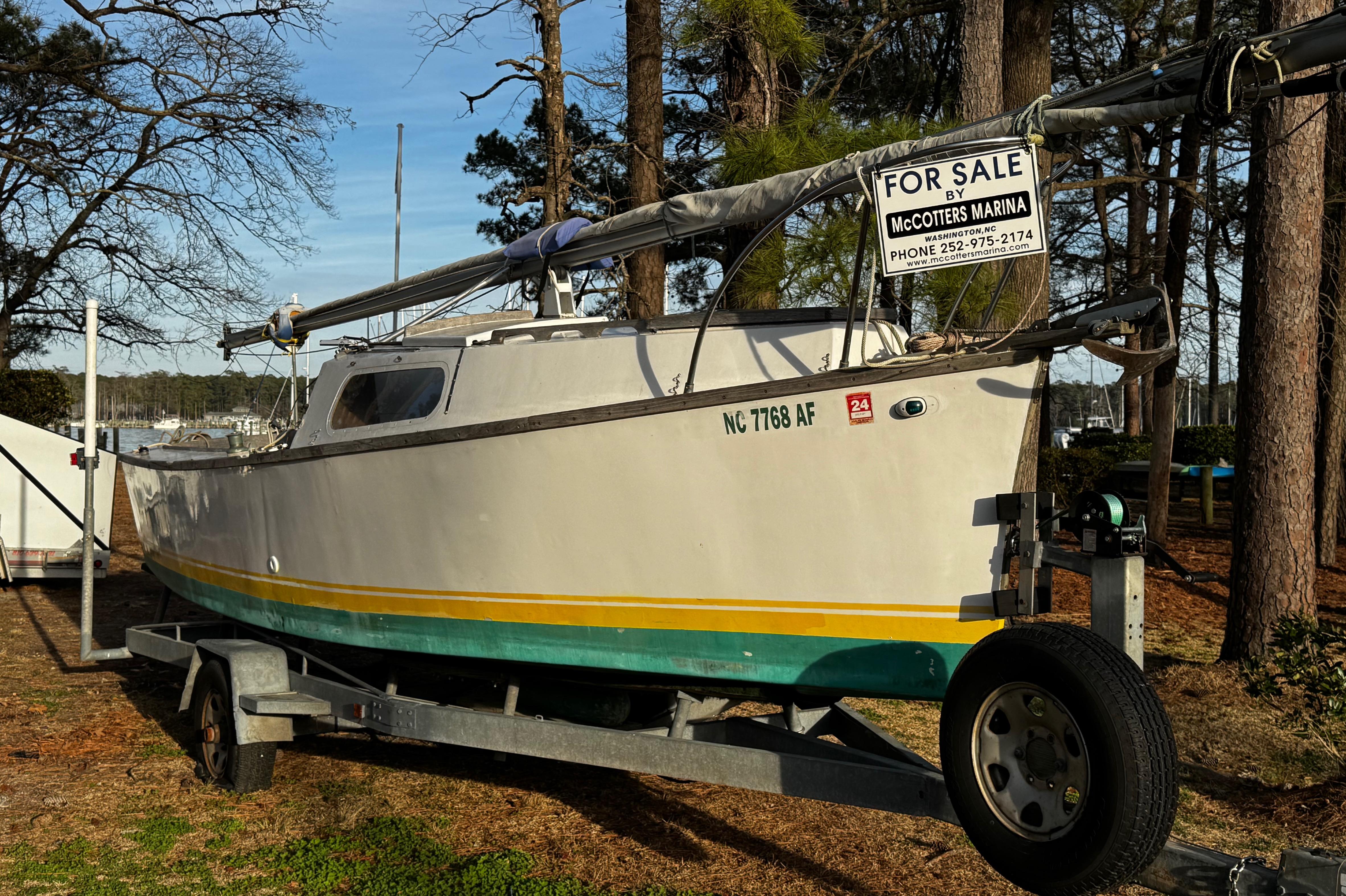 1976 Custom Wooden Sloop for sale at McCotters Marina, on trailer in wooded area.
