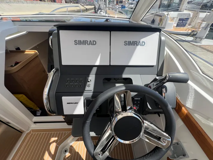 Mdr #297 In Stock Yacht Photos Pics 2024 Nimbus W9 boat dashboard with Simrad displays and Mercury controls.