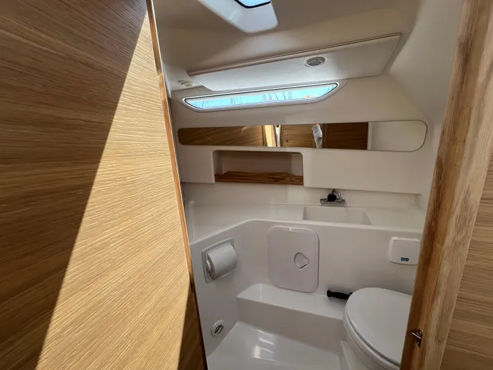 Mdr #297 In Stock Yacht Photos Pics Modern bathroom interior in 2024 Nimbus W9 boat, featuring wood accents and sleek design.