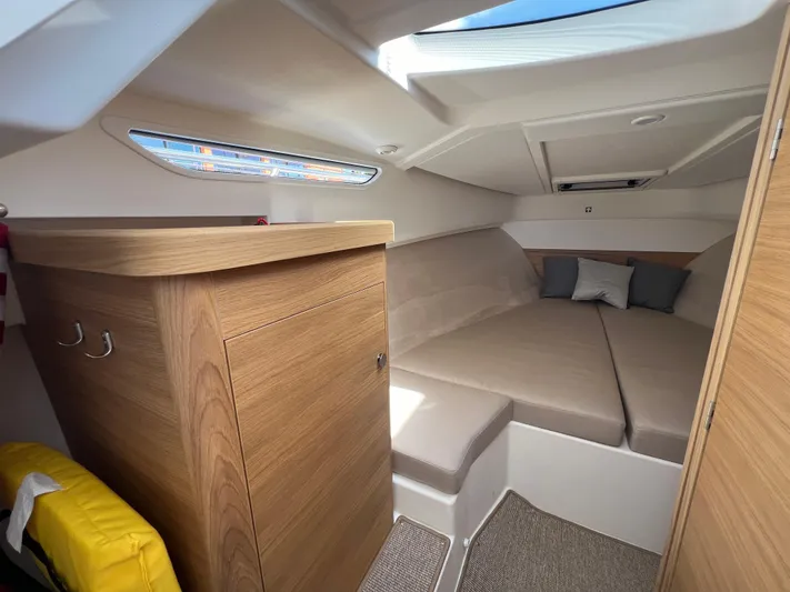 Mdr #297 In Stock Yacht Photos Pics Cozy interior cabin of 2024 Nimbus W9 boat with modern wood finish and comfortable seating.