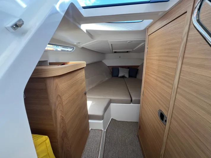 Mdr #297 In Stock Yacht Photos Pics 2024 Nimbus W9 boat interior with cozy cabin and modern wood finish.