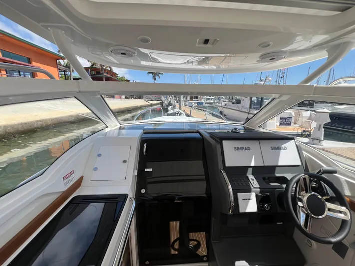 Mdr #297 In Stock Yacht Photos Pics 2024 Nimbus W9 boat cockpit with modern controls and panoramic windows.