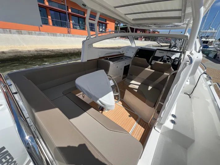 Mdr #297 In Stock Yacht Photos Pics 2024 Nimbus W9 boat interior with beige seating and modern dashboard.