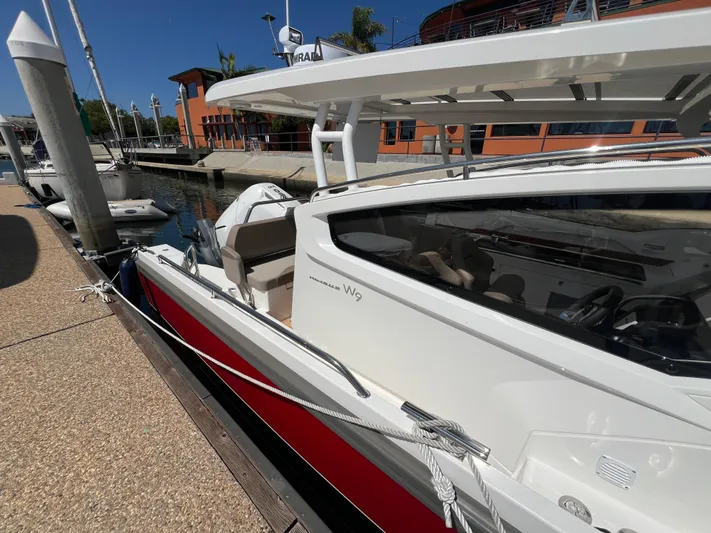 Mdr #297 In Stock Yacht Photos Pics 2024 Nimbus W9 boat docked at marina under clear blue sky.