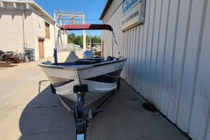 1997 Sea Nymph 168 DLX boat on trailer beside a metal building.