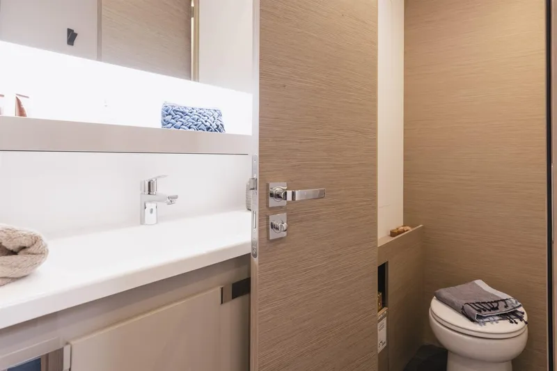  Yacht Photos Pics 2025 Fountaine Pajot Catamaran Aura 51 bathroom with modern fixtures and sleek design.