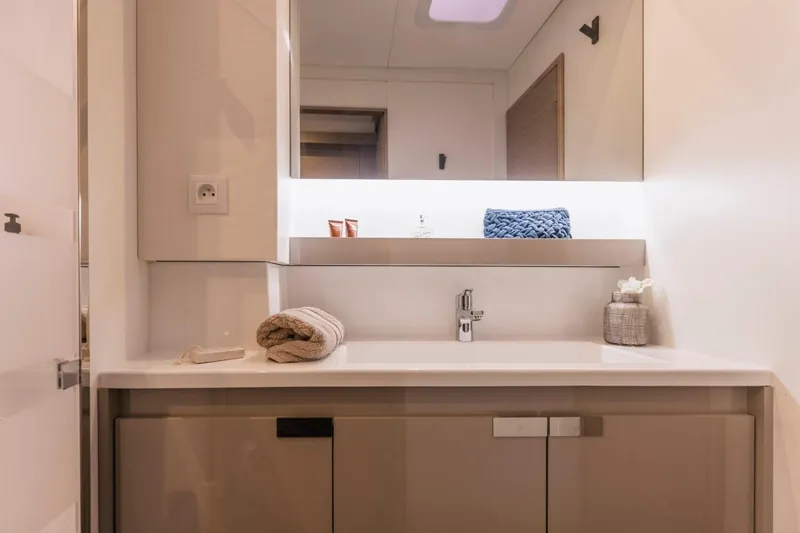  Yacht Photos Pics Modern bathroom interior of 2025 Fountaine Pajot Catamaran Aura 51, featuring sleek design elements.