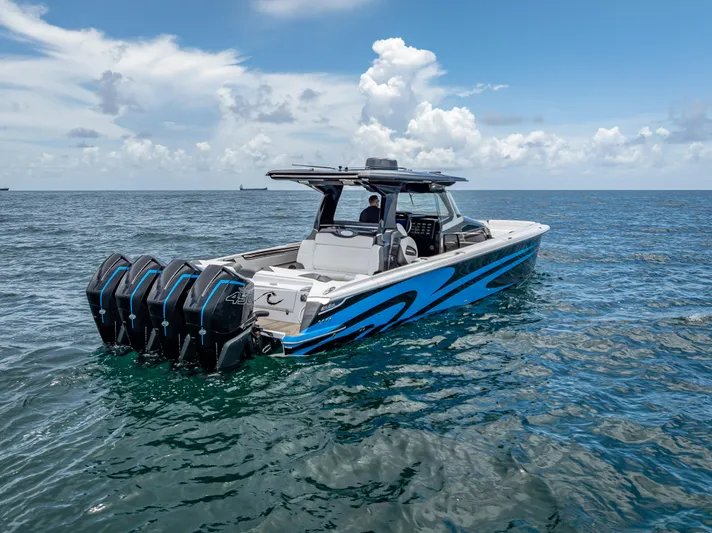  Yacht Photos Pics 2022 Nor-Tech 450 Sport boat with four engines on open water under a blue sky.