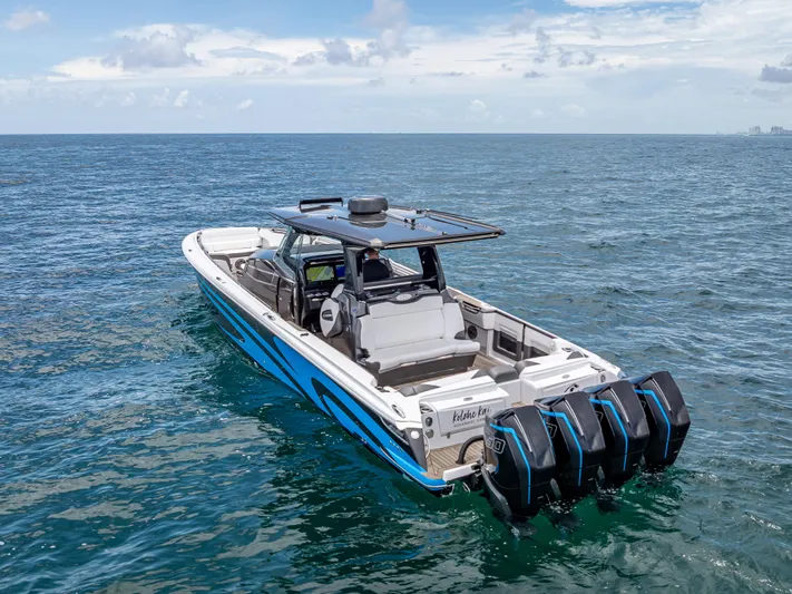  Yacht Photos Pics 2022 Nor-Tech 450 Sport boat on open water, featuring four powerful outboard engines.