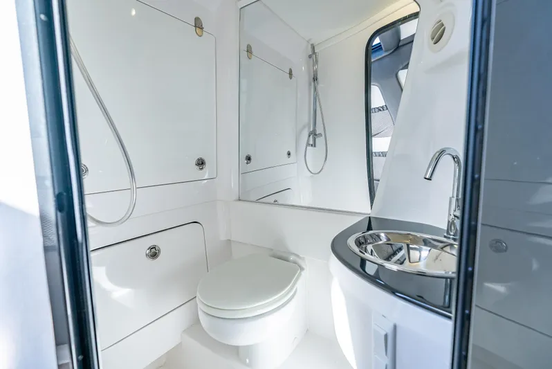  Yacht Photos Pics Luxurious bathroom in 2022 Nor-Tech 450 Sport boat with modern fixtures and sleek design.