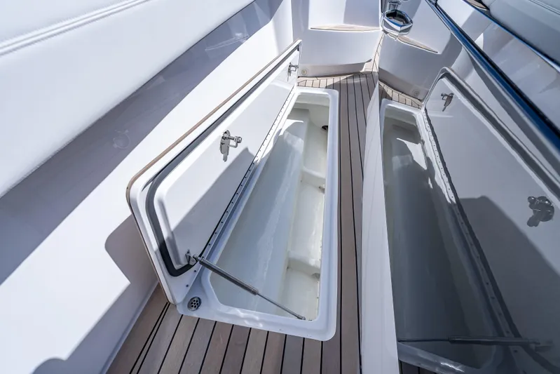  Yacht Photos Pics Open storage compartment on 2022 Nor-Tech 450 Sport boat, featuring sleek design and wood flooring.