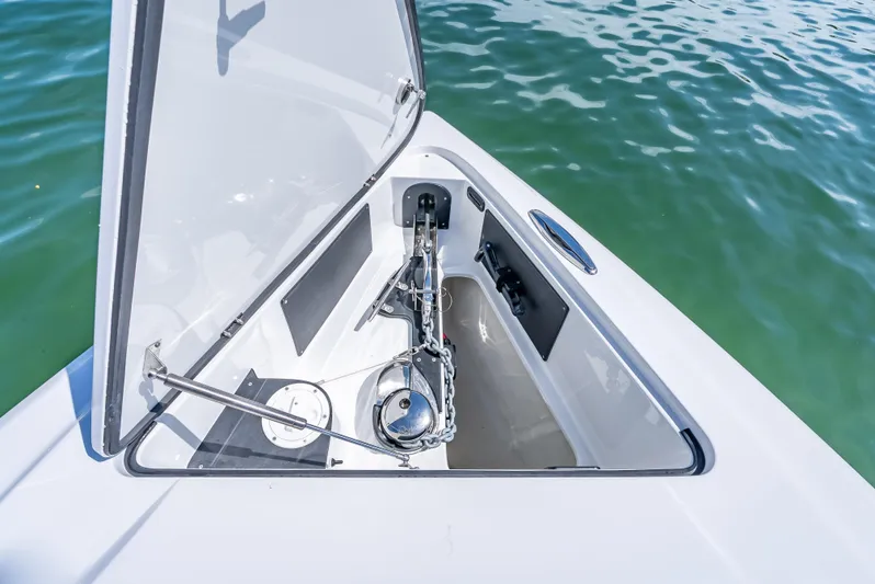 Yacht Photos Pics 2022 Nor-Tech 450 Sport boat anchor compartment with open hatch, on calm water.