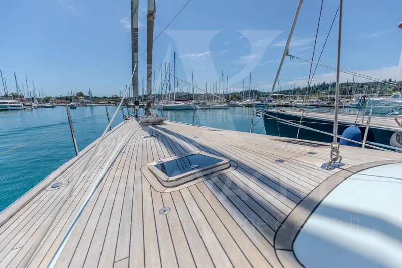 Satori Yacht Photos Pics Deck view of 2005 Farr 64 yacht in a marina, clear blue sky.