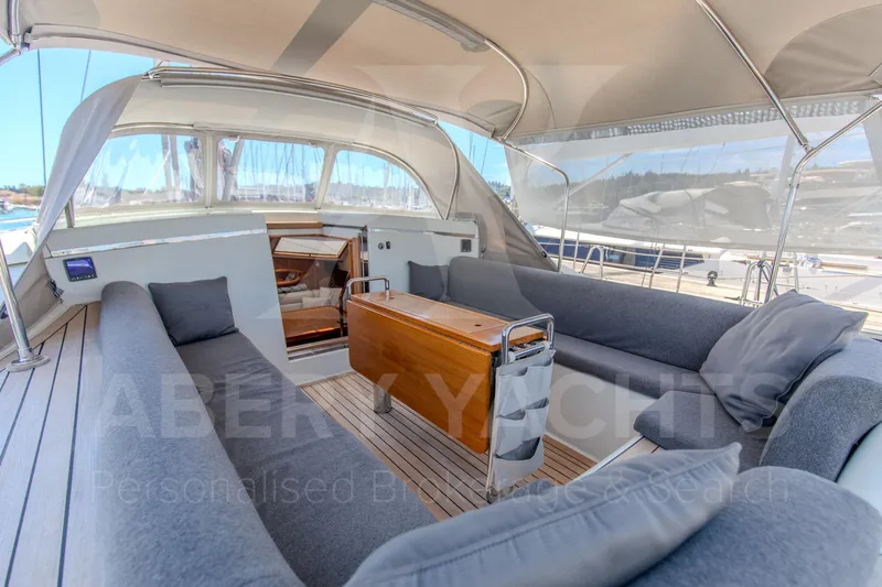 Satori Yacht Photos Pics Luxurious 2005 Farr 64 yacht interior with spacious seating and elegant wooden table.