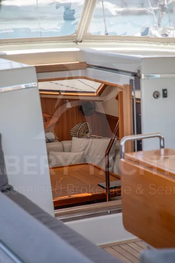 Satori Yacht Photos Pics Interior view of a 2005 Farr 64 yacht, showcasing a cozy cabin with wooden accents.