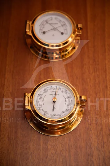 Satori Yacht Photos Pics Brass nautical instruments on wooden surface, Farr 64, 2005 model.