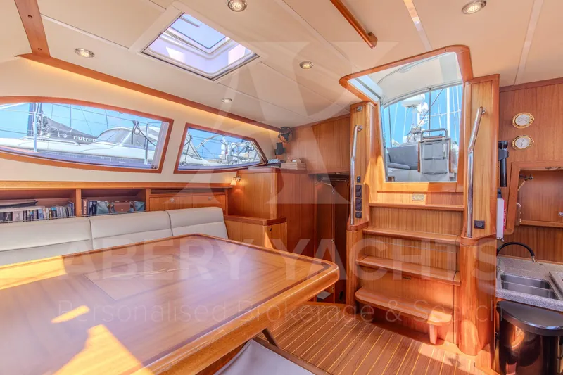 Satori Yacht Photos Pics Luxurious interior of 2005 Farr 64 yacht with wooden finishes and ample natural light.
