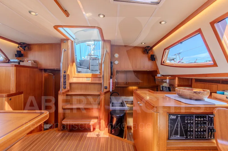 Satori Yacht Photos Pics Luxurious interior of a 2005 Farr 64 yacht with wooden finishes and modern amenities.