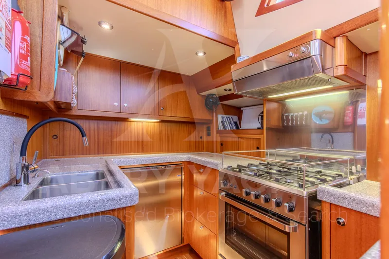 Satori Yacht Photos Pics Luxurious Farr 64 yacht kitchen, 2005 model, featuring modern appliances and elegant wood cabinetry.