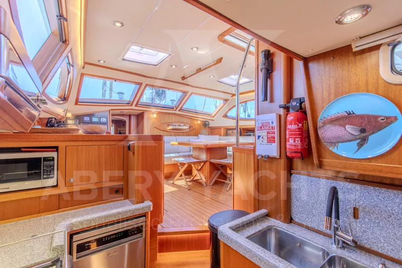 Satori Yacht Photos Pics Luxurious interior of a 2005 Farr 64 yacht with modern kitchen and dining area.