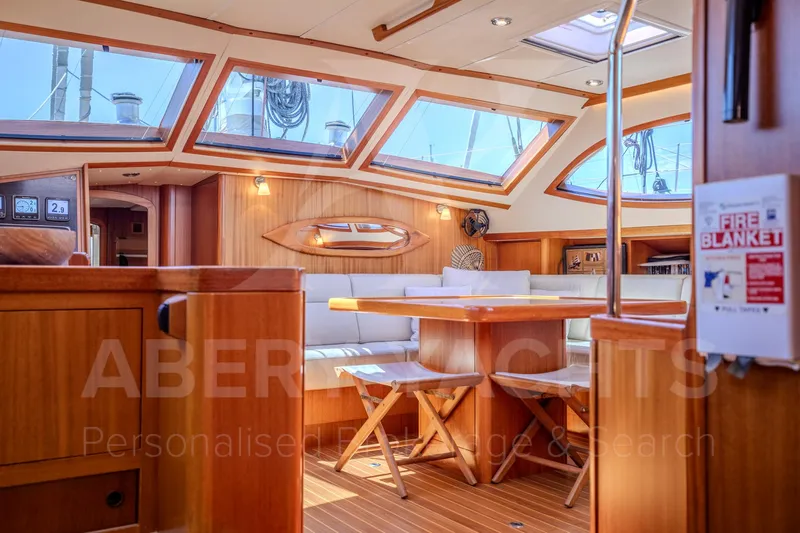 Satori Yacht Photos Pics Luxurious Farr 64 yacht interior, 2005 model, featuring elegant wood finishes and spacious seating.