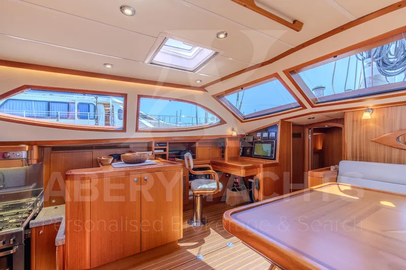 Satori Yacht Photos Pics Luxurious interior of 2005 Farr 64 yacht with wooden finishes and ample natural light.