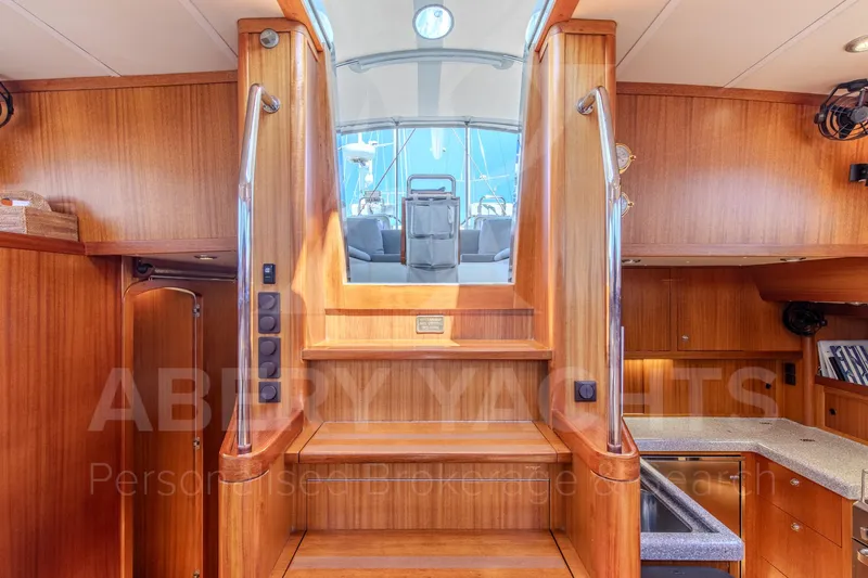 Satori Yacht Photos Pics Interior of 2005 Farr 64 yacht with wooden stairs and modern design.