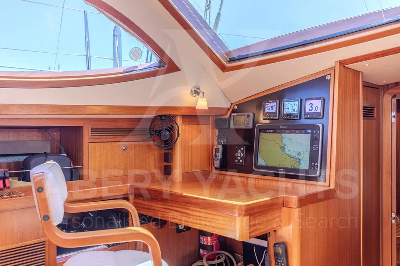 Satori Yacht Photos Pics Interior of 2005 Farr 64 yacht with navigation equipment and wooden finish.