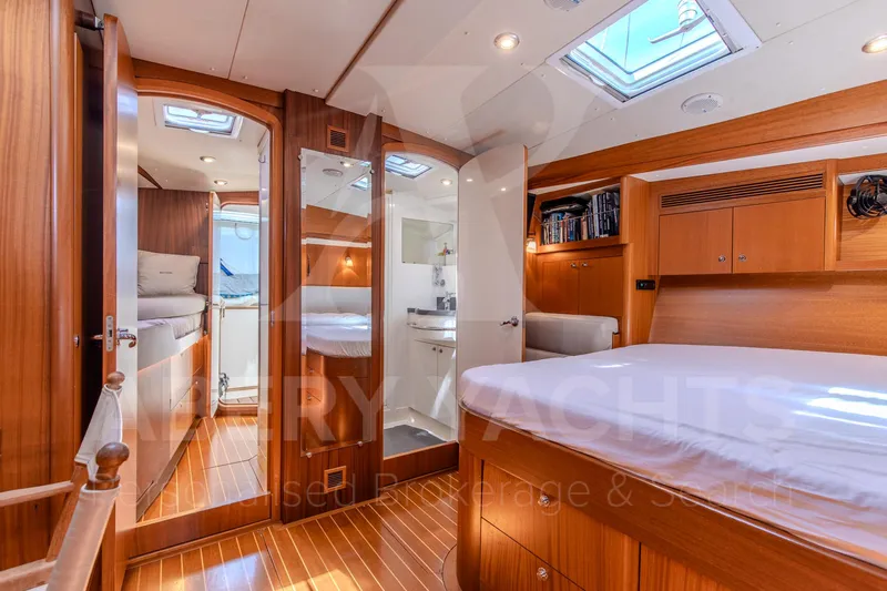 Satori Yacht Photos Pics Luxurious Farr 64 yacht interior, featuring elegant wood finishes and spacious sleeping quarters, 2005 model.