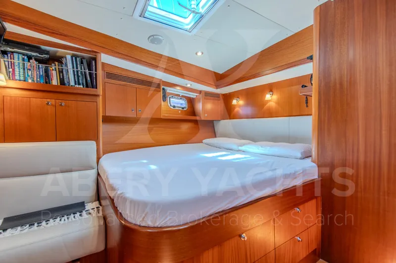 Satori Yacht Photos Pics Luxurious cabin interior of 2005 Farr 64 yacht with wooden furnishings and skylight.